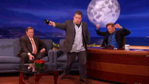 Patton Oswalt as guest on Conan O'Brien pours out mug of water on the ground