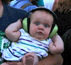 Baby with ear protection headphones with crazy eyes!